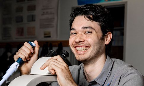 Duncan Anderson '24 Posing With Syringe and Microscope