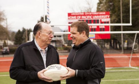 Coach Buckley presents Bob Schurman with football