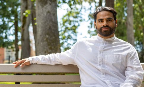 Wesley Heredia Sitting On Bench On Pacific University Forest Grove Campus