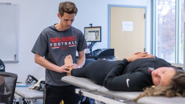 athletic training student with a client