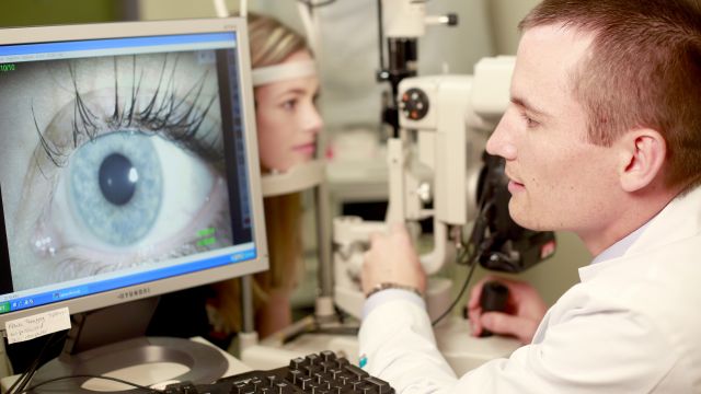 optometrist performing eye exam