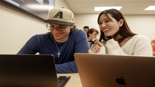 Two Pacific University students in a business class