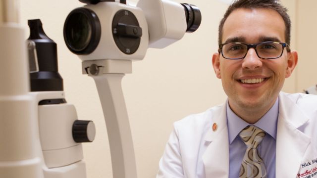 A Pacific University optometry student poses in the EyeClinic