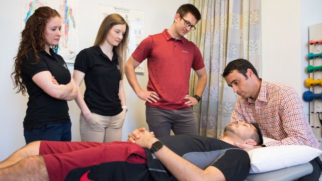 A Pacific University physical therapy professor demonstrates a technique for students