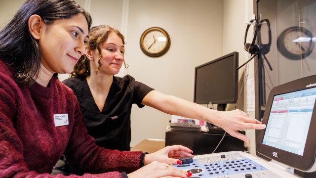 Students look at a monitor in the Pacific University audiology program