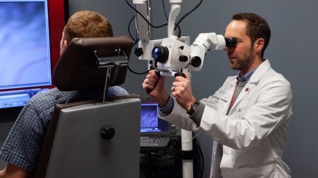 An audiologist uses cameras to examine a patient's inner ear at Pacific University