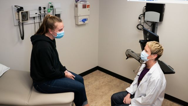 A healthcare provider and patient in the student and employee health center