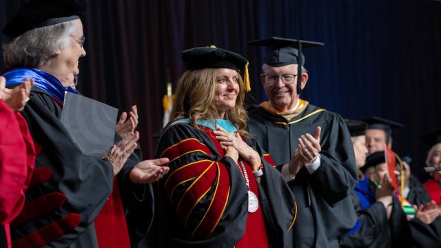 President Jenny Coyle on stage at her inauguration