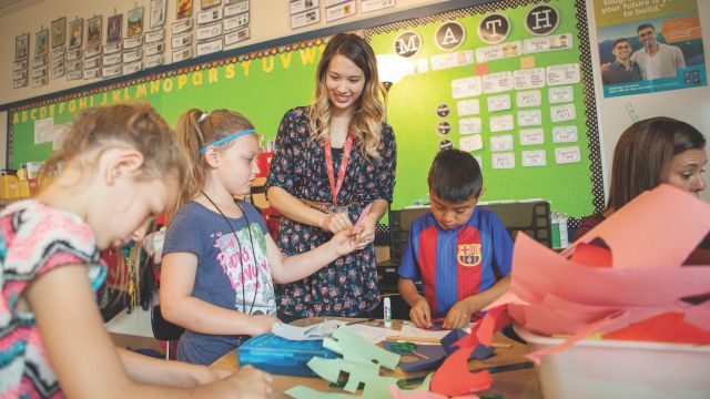 Someone teaching young students in a classroom