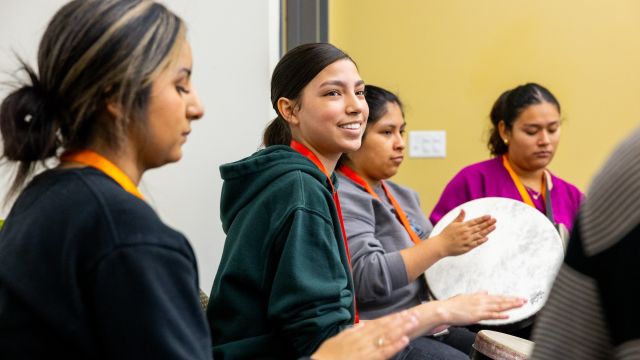 student hitting a drum