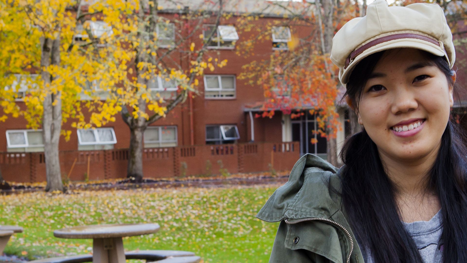 A student standing outside of Clark Hall