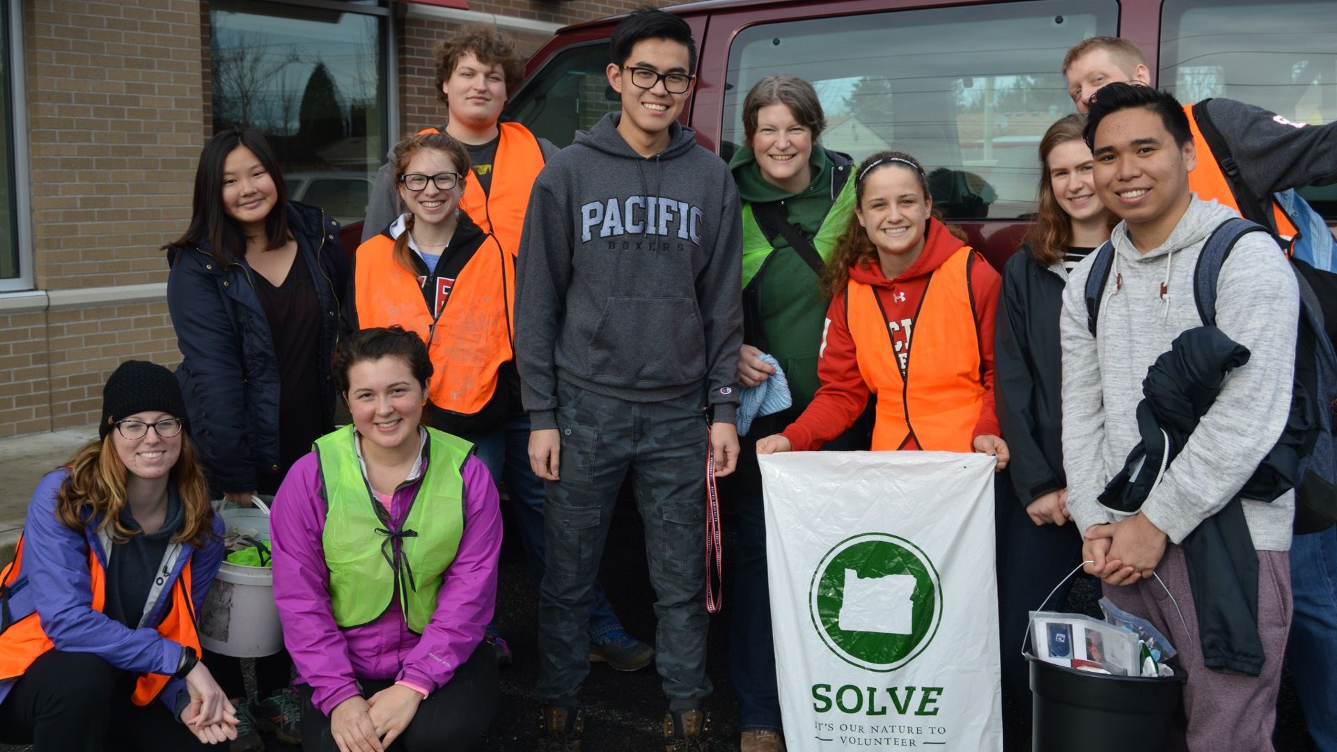 Students doing Civic Engagement wearing orange vests