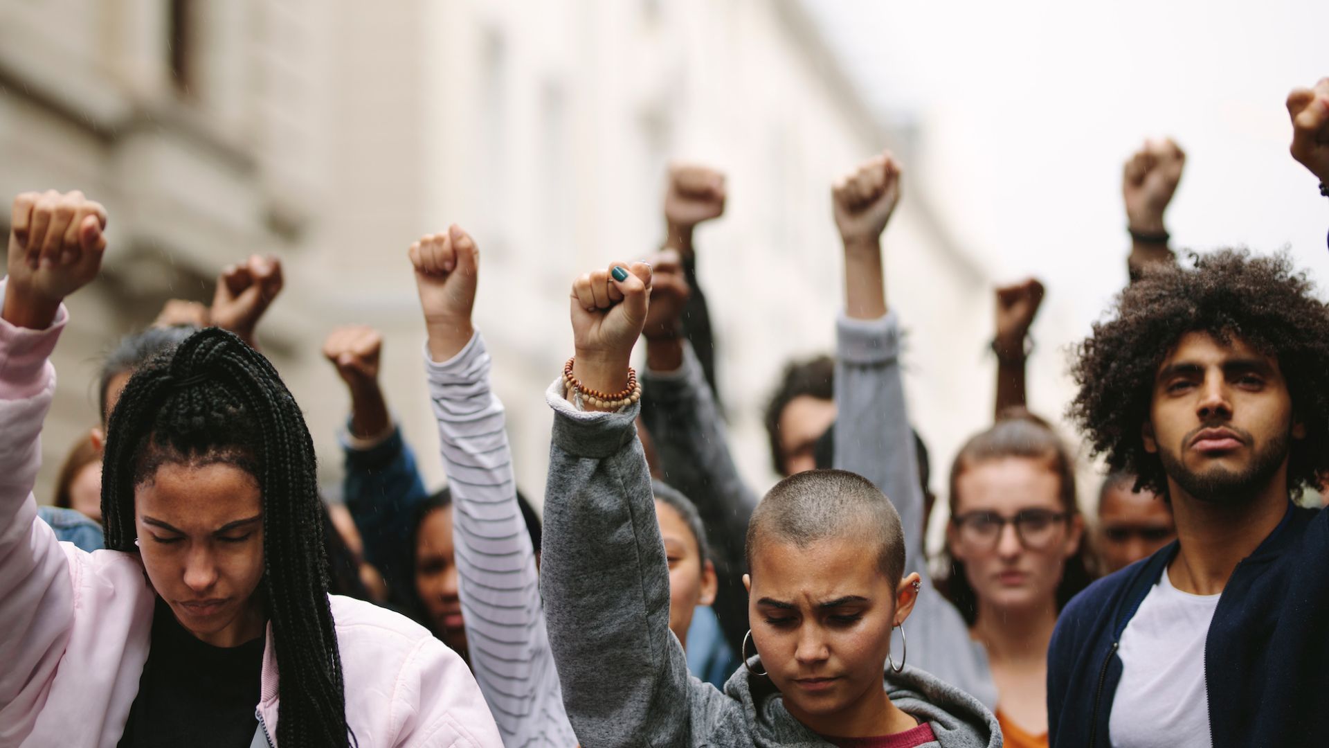 students with fists in the air